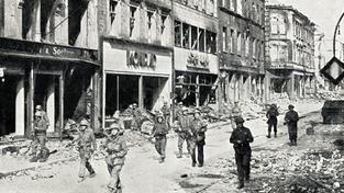 US-Truppen maschieren im März 1945 durch die heutige Eisenbahnstraße in Saarbrücken, auf der Suche nach letzten deutschen Scharfschützen (Foto: IMAGO / Gemini Collection)